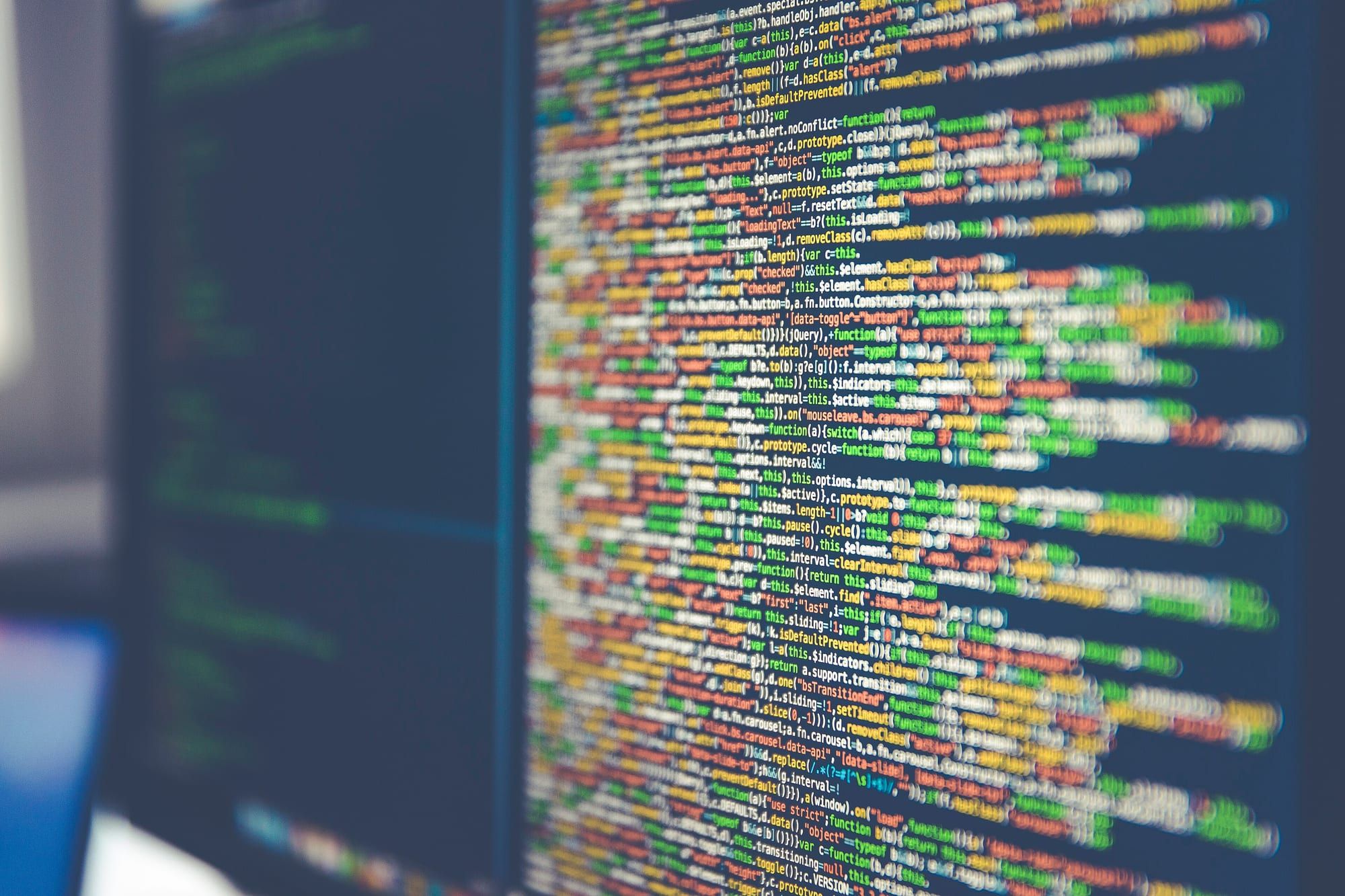 Blurred lines of colourful programming code on a computer monitor